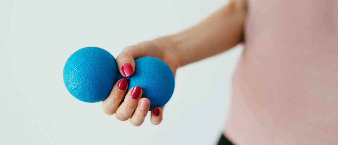 Faceless young woman with stress ball on white background