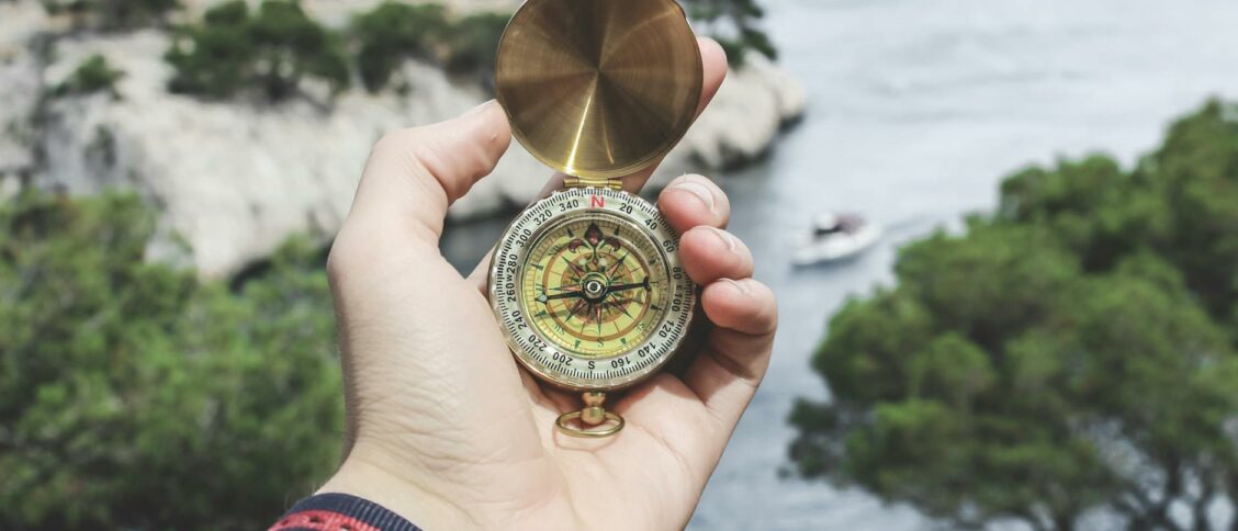 Person Holding Compass