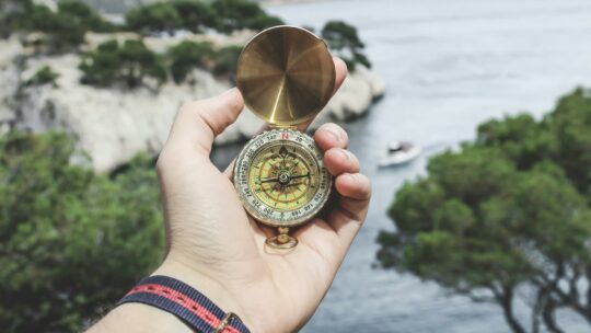 Person Holding Compass