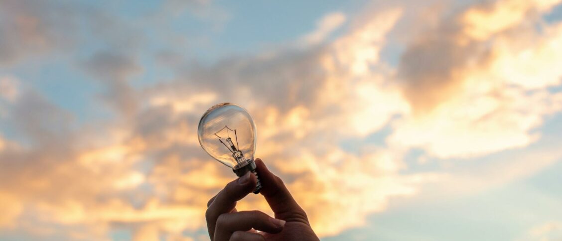 Person Holding Clear Light Bulb