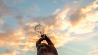 Person Holding Clear Light Bulb