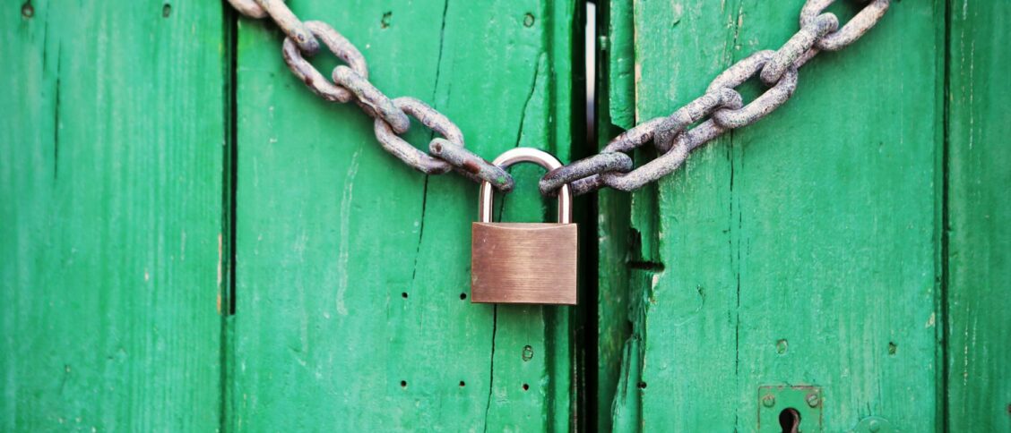 Brass-colored Metal Padlock With Chain