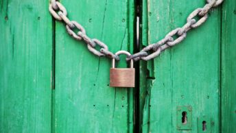 Brass-colored Metal Padlock With Chain