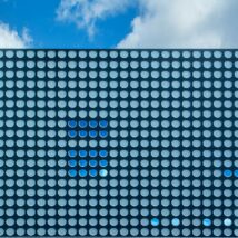 A large blue and white building with a blue sky